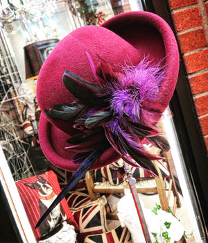 Maroon rolled brim Cloche with feather corsage